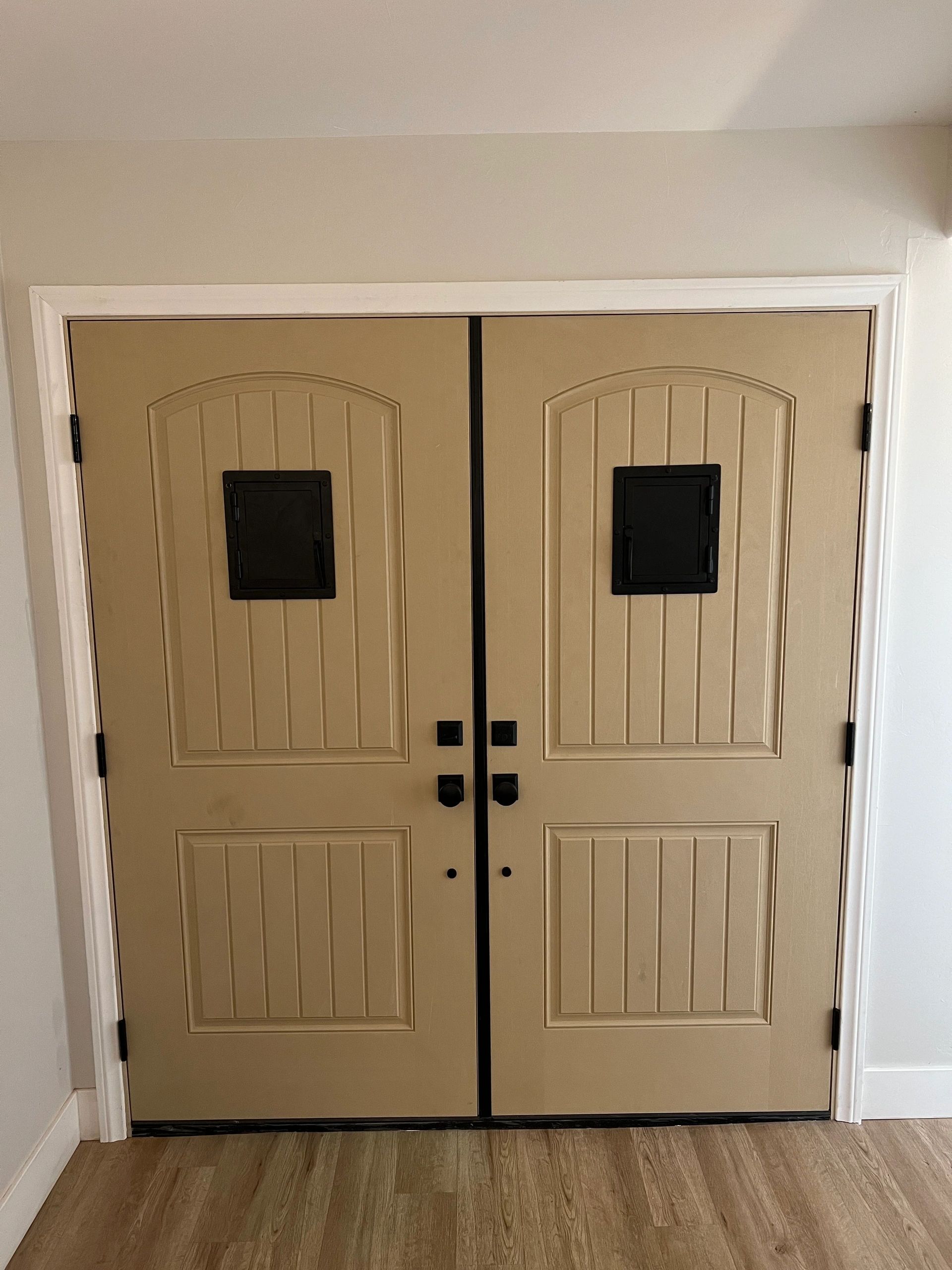 Tan double doors with black hardware